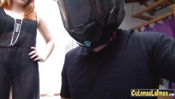Red-haired girl in black boots and boyfriend in motorcycle helmet